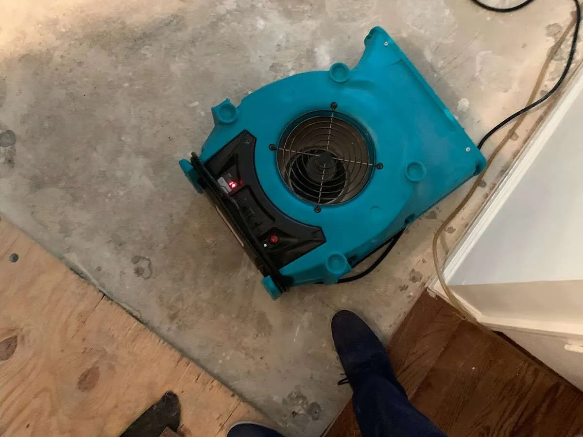 Air mover drying subfloor during Commercial Water Damage Restoration in Gallup